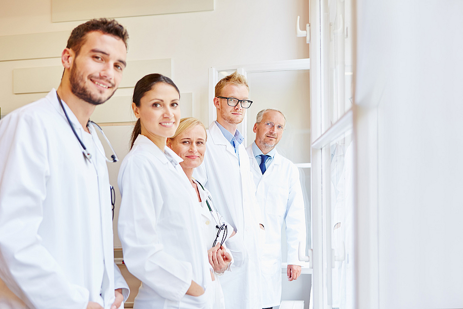 Ärzt*innen in Weiterbildung, die gemeinsam in die Kamera schauen